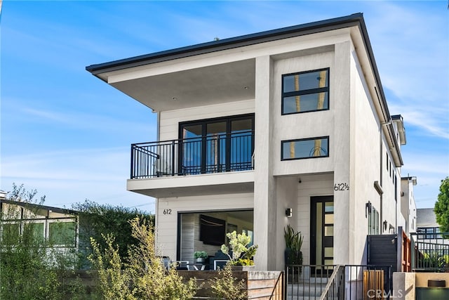 back of house featuring a balcony