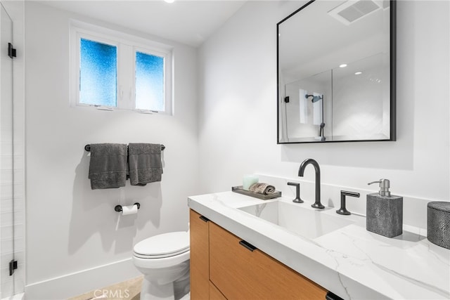 bathroom with toilet, vanity, tile patterned flooring, and an enclosed shower