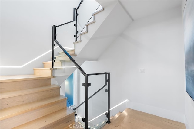 staircase featuring hardwood / wood-style flooring