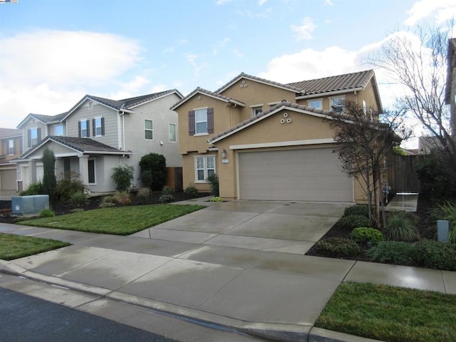 view of property featuring a garage and a front yard