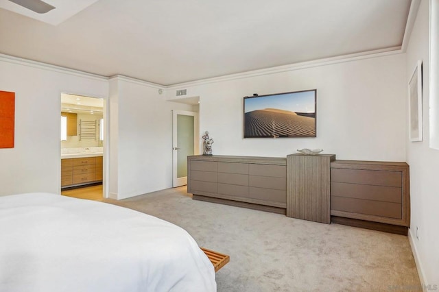 carpeted bedroom featuring ensuite bathroom and crown molding