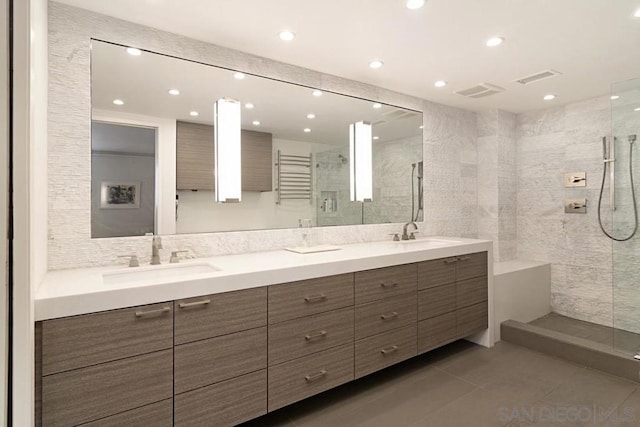 bathroom featuring tile walls, tile patterned floors, vanity, and tiled shower