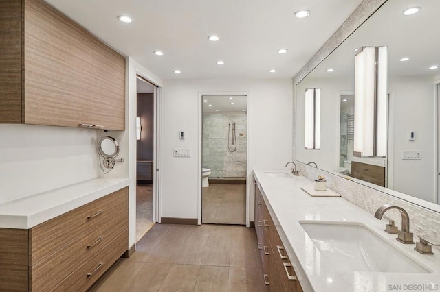 bathroom with walk in shower, vanity, and tile patterned flooring