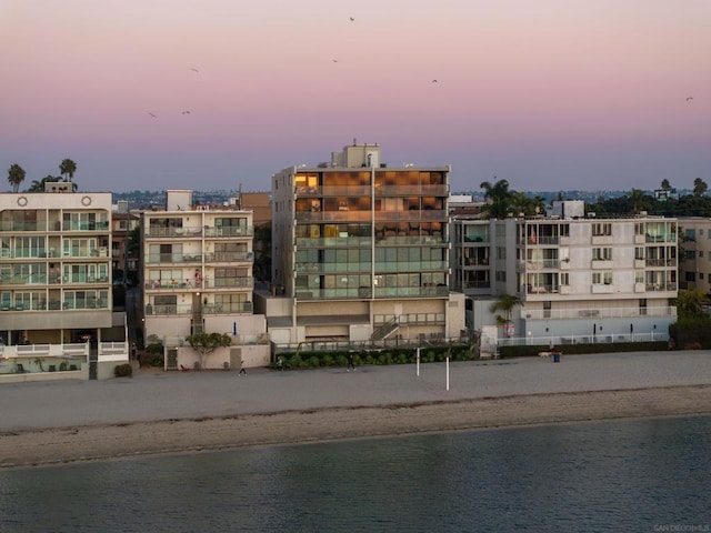 outdoor building at dusk with a view of the beach and a water view