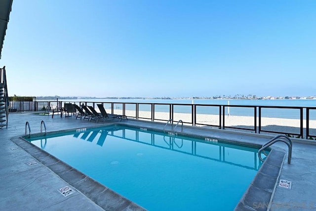 view of pool with a water view