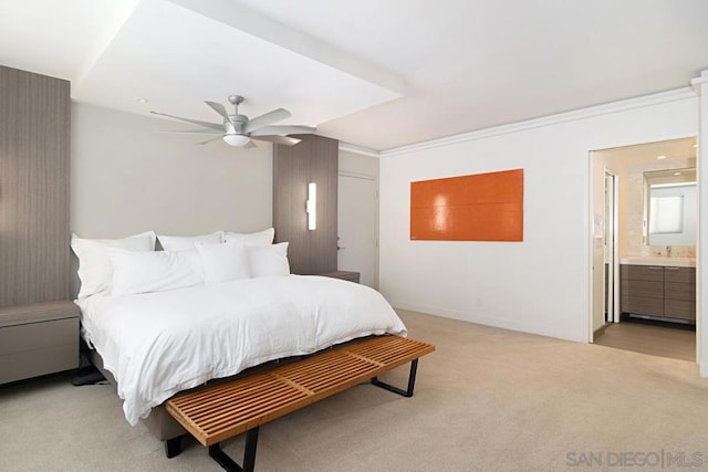 carpeted bedroom featuring ceiling fan, ornamental molding, connected bathroom, and sink