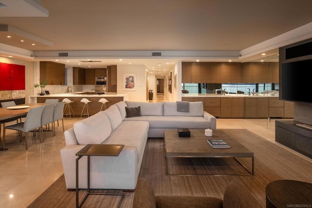 living room with sink and light tile patterned flooring