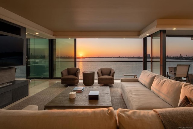 interior space with a water view and a wall of windows