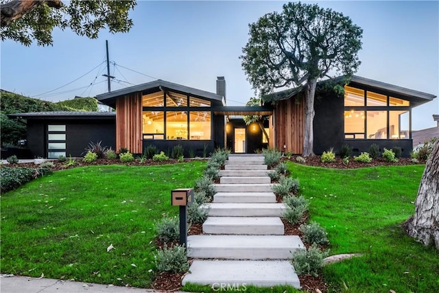 contemporary home with a sunroom and a front yard