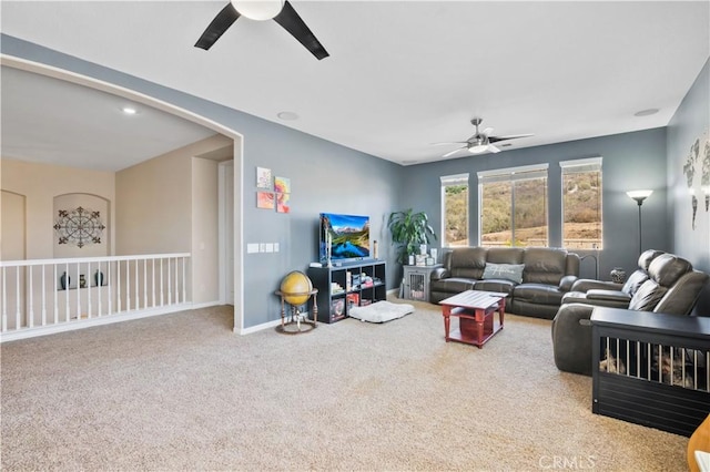 carpeted living room featuring ceiling fan