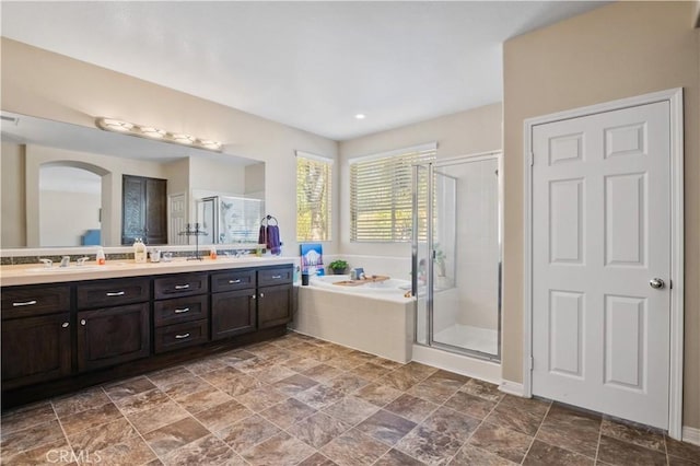 bathroom with vanity and independent shower and bath