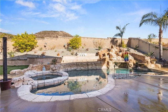 view of swimming pool with an in ground hot tub and a patio area