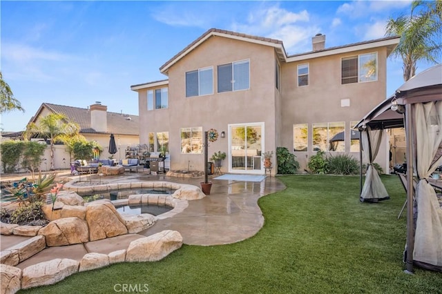 back of house featuring a gazebo, a yard, and a patio area