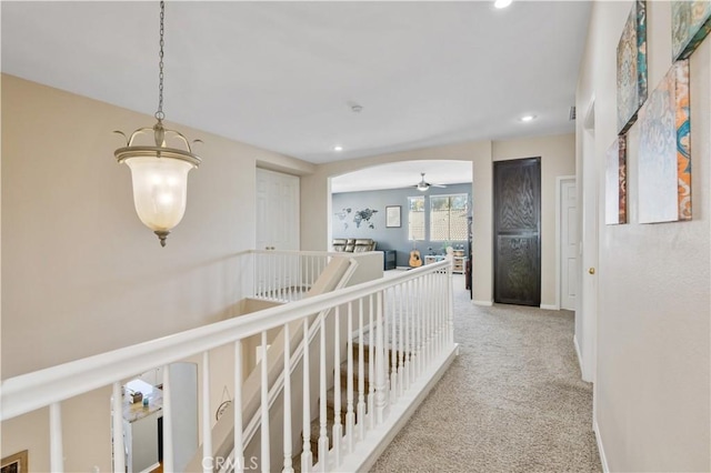 hallway with light colored carpet