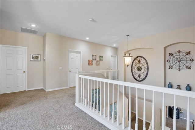 hallway featuring light carpet