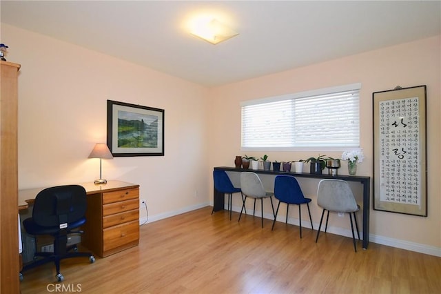 office space with light wood-type flooring