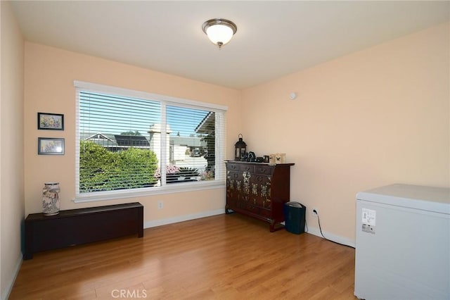 interior space with fridge and light hardwood / wood-style floors