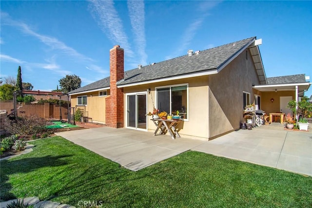 rear view of property featuring a yard and a patio