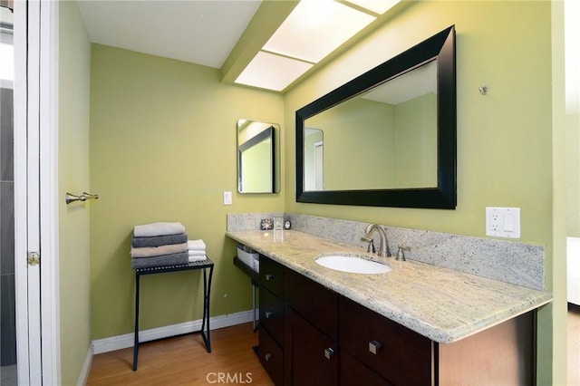 bathroom featuring hardwood / wood-style flooring and vanity