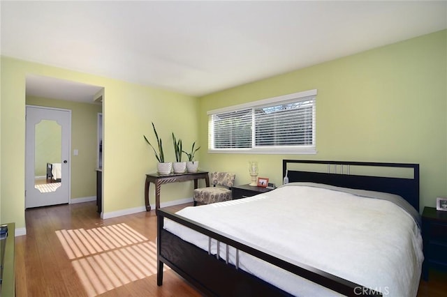 bedroom with hardwood / wood-style flooring