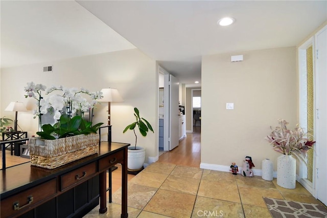 hall featuring light tile patterned flooring