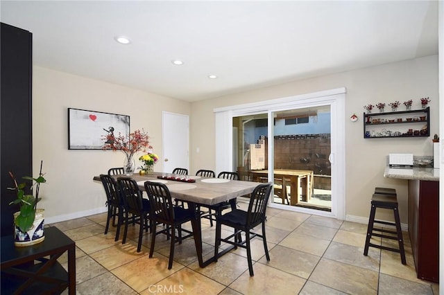 dining space featuring light tile patterned flooring