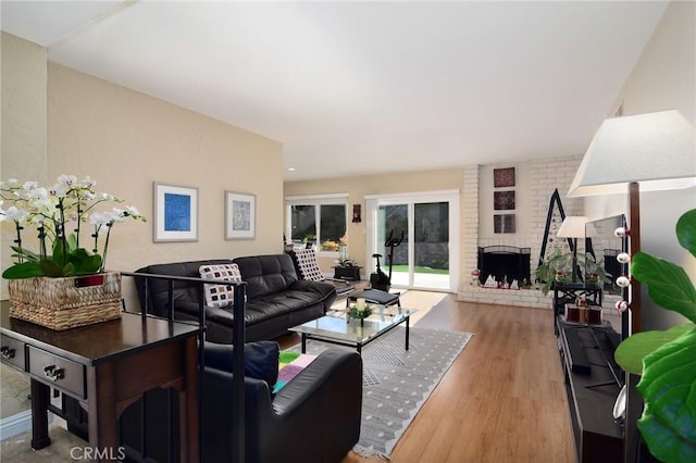 living room featuring wood-type flooring and a fireplace