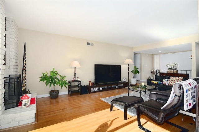 living room with a fireplace and hardwood / wood-style floors