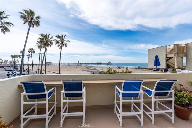 view of patio / terrace with a water view and a balcony