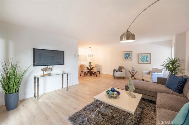 living room with hardwood / wood-style floors and a notable chandelier