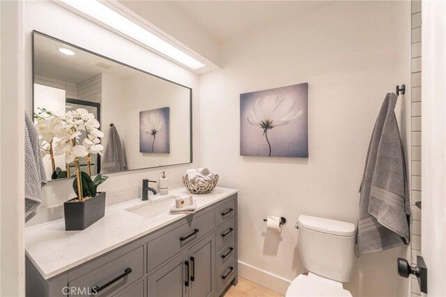 bathroom featuring toilet and vanity