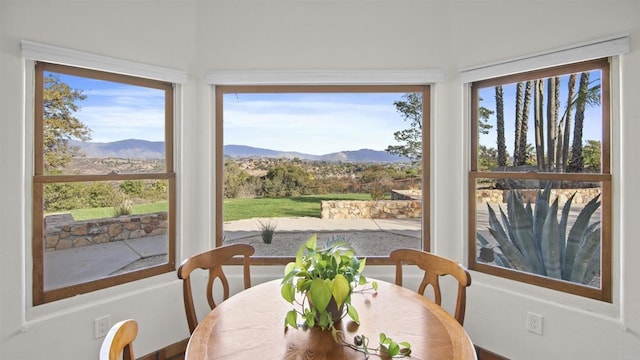 dining room featuring a mountain view and a wealth of natural light