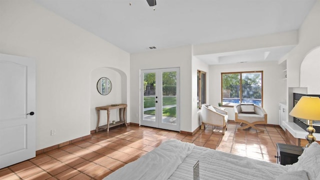 bedroom featuring ceiling fan, access to exterior, multiple windows, and french doors