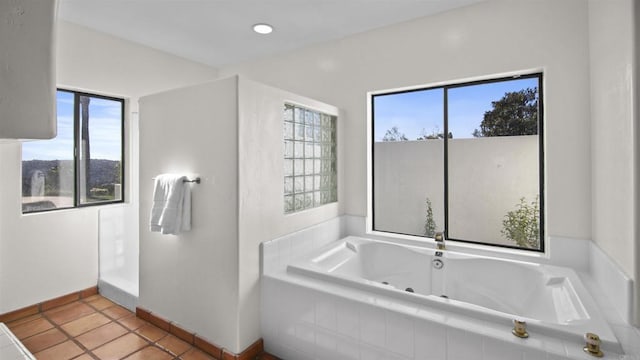 bathroom featuring tile patterned floors and tiled tub