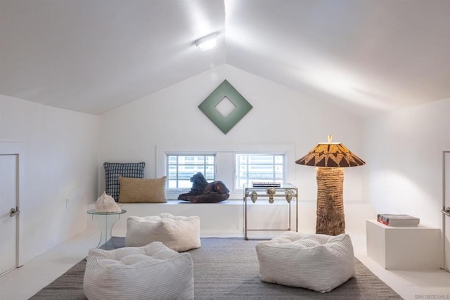 bedroom featuring carpet and vaulted ceiling