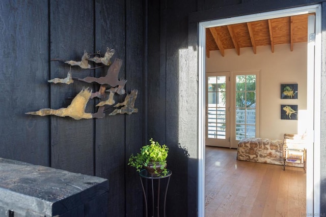 interior space featuring vaulted ceiling with beams and wood-type flooring