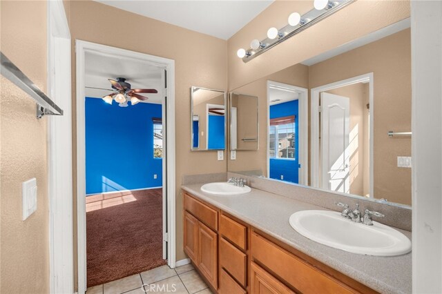 bathroom with tile patterned flooring, vanity, and ceiling fan