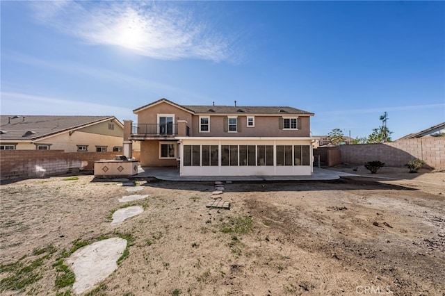 back of house featuring a patio area, a hot tub, and a sunroom