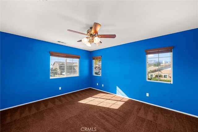 empty room with ceiling fan and carpet