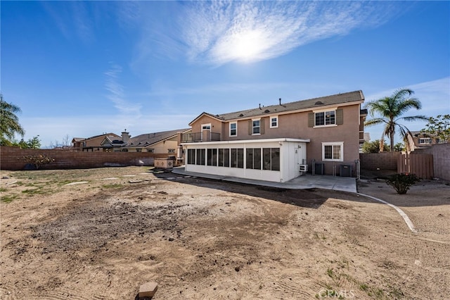 back of house featuring a sunroom and a patio area