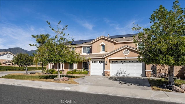 view of front of property featuring a mountain view and solar panels