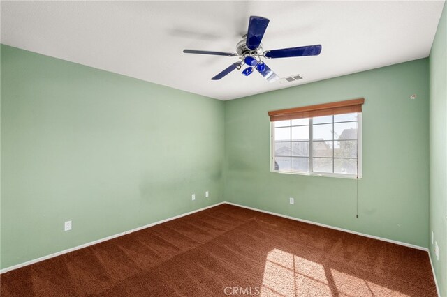 unfurnished room featuring ceiling fan and carpet