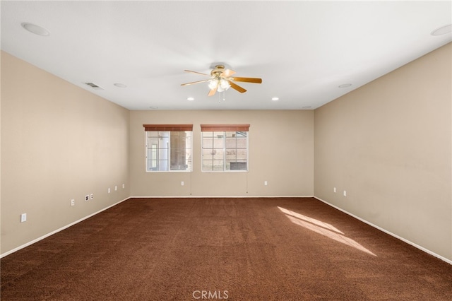 unfurnished room with ceiling fan and carpet