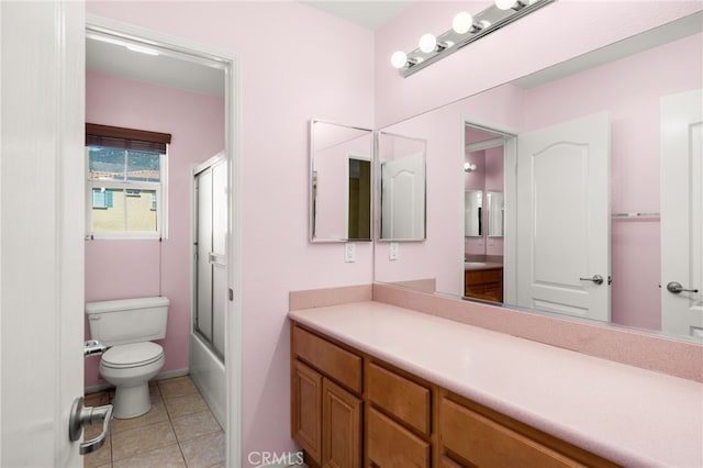 full bathroom with enclosed tub / shower combo, vanity, toilet, and tile patterned floors