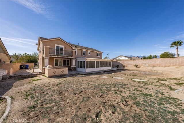 rear view of property with a balcony