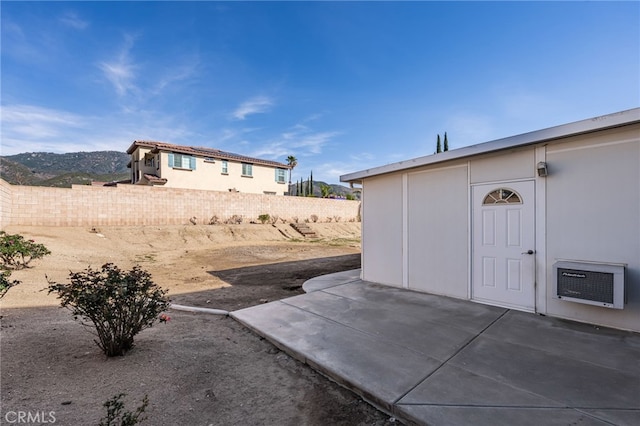 view of yard with a patio, a mountain view, and a wall unit AC