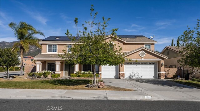 view of front of house with a garage and solar panels