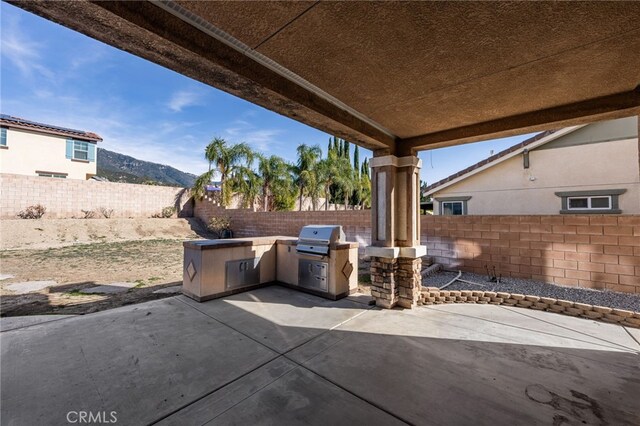 view of patio / terrace with a mountain view, area for grilling, and grilling area