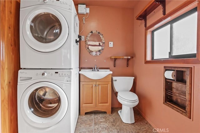 laundry room with stacked washing maching and dryer and sink