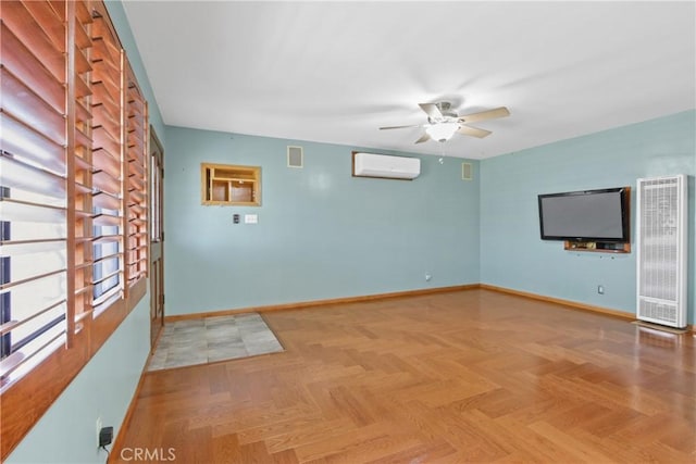 unfurnished living room with ceiling fan, an AC wall unit, and parquet floors